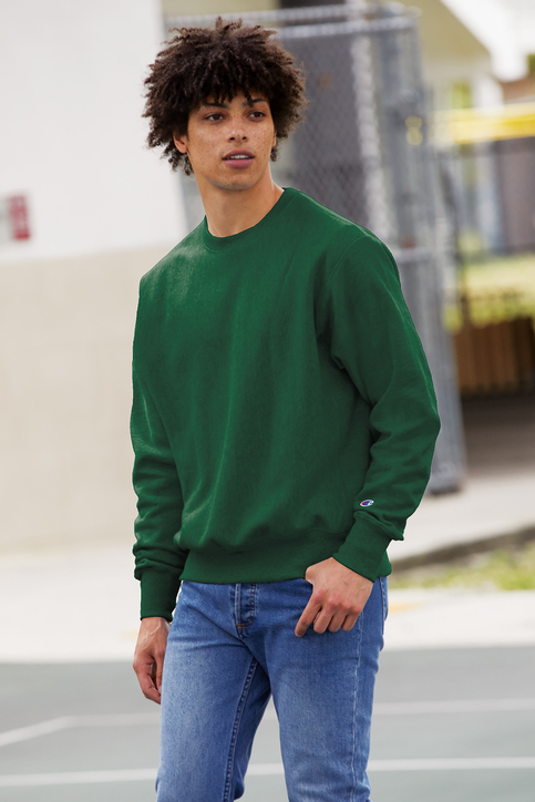 A man wearing a green crewneck.