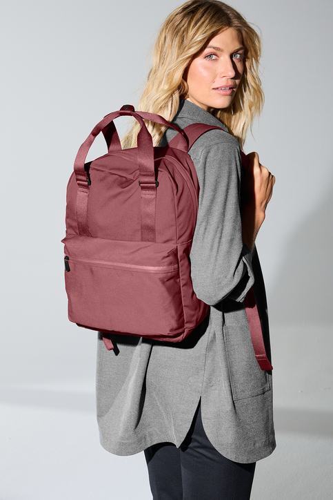 A woman wearing a pink backpack
