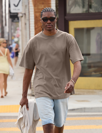 A man walking, wearing a T shirt.